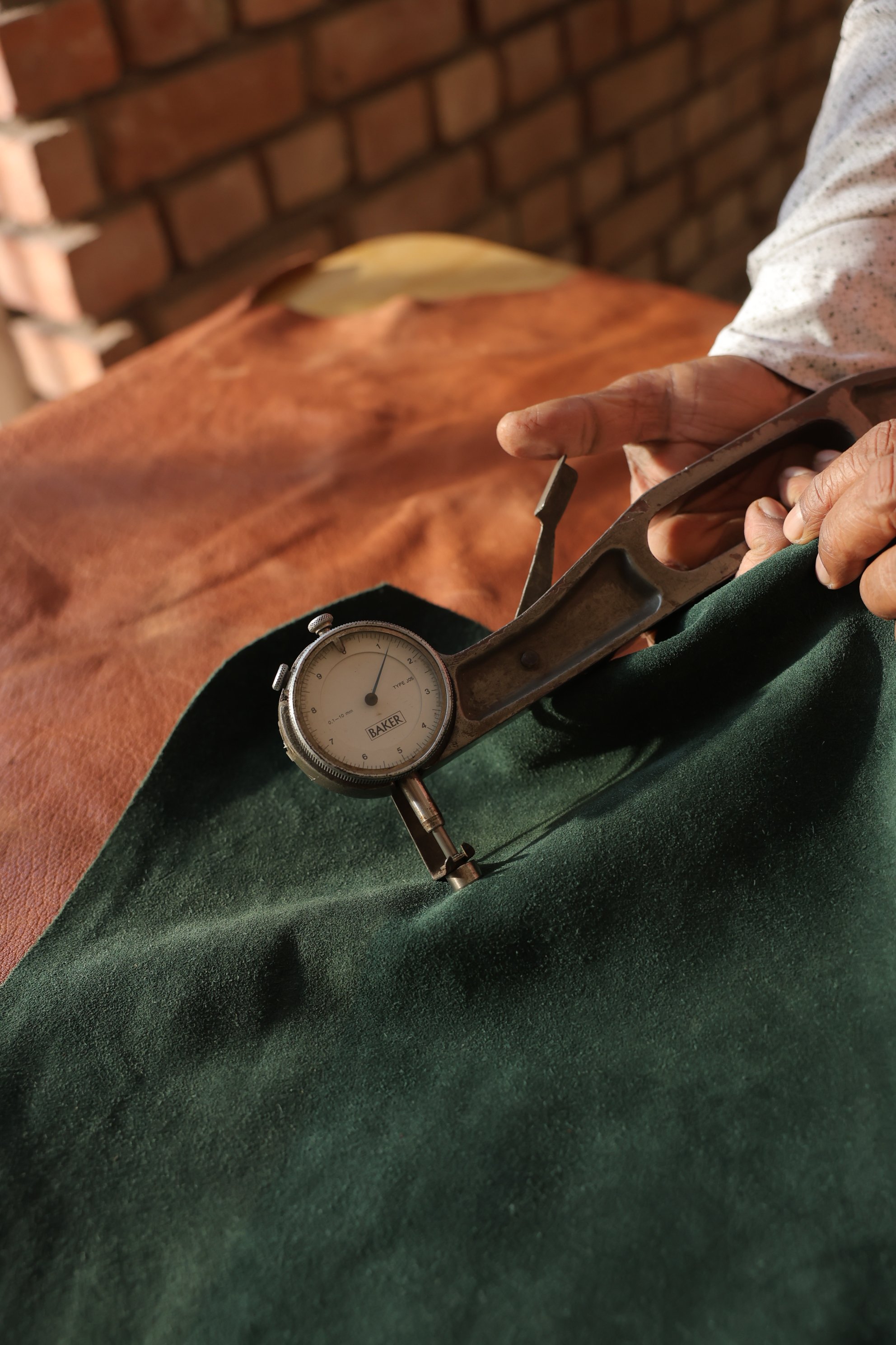 Close-up of hand-stitched sustainable leather craftsmanship at Raja & Mitsu Fashions